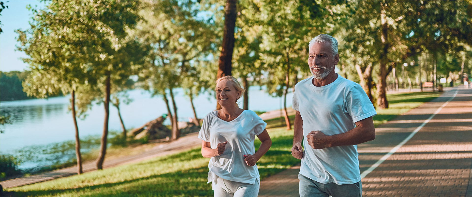 Senior man and woman running at the park